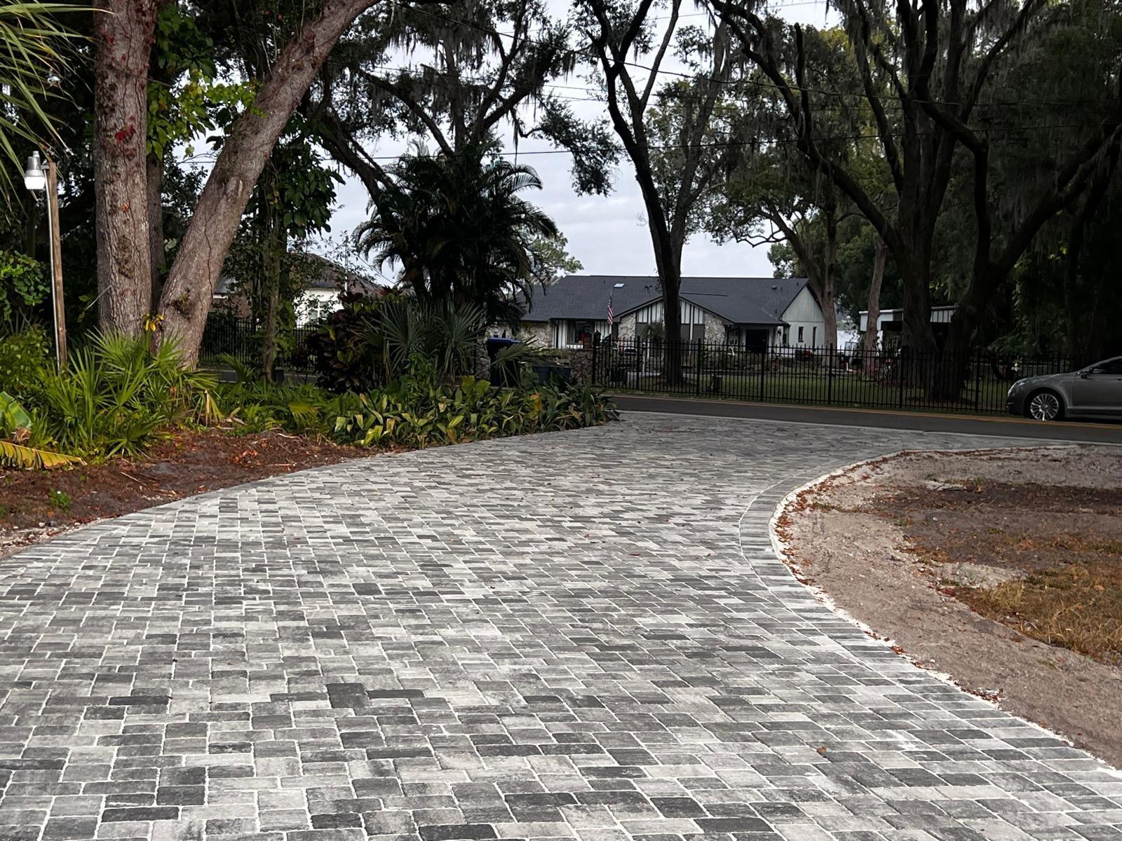 Paver driveway beneath mature live oaks in Winter Park, FL