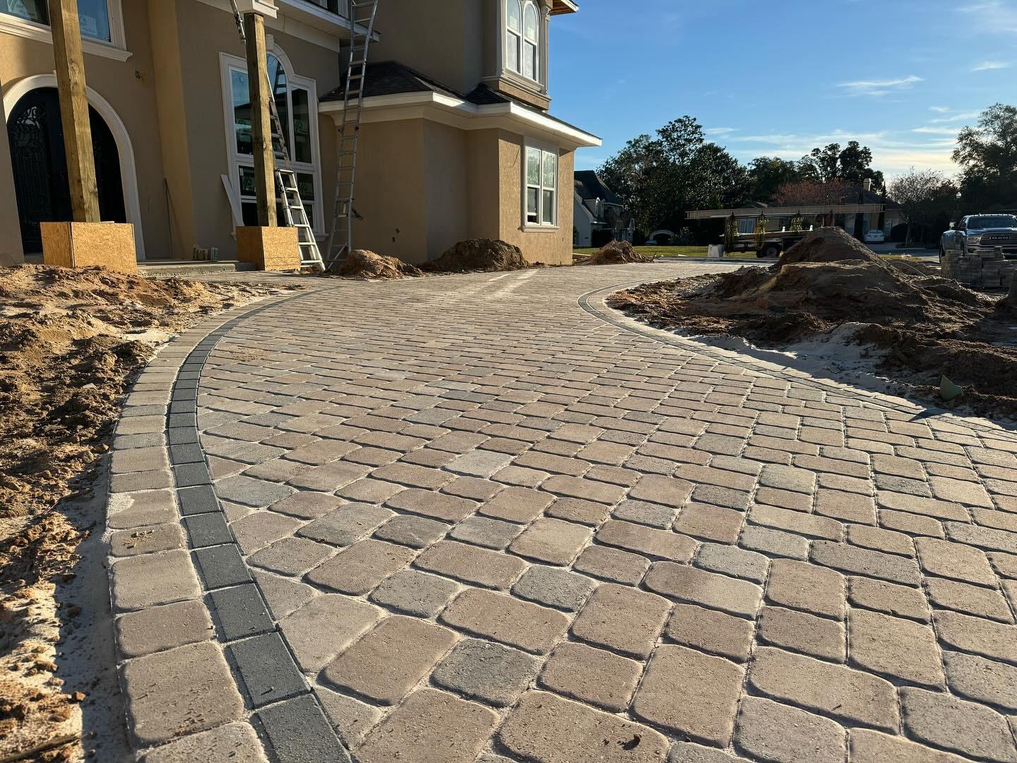 Curved cobble paver driveway installation at a Central Florida estate