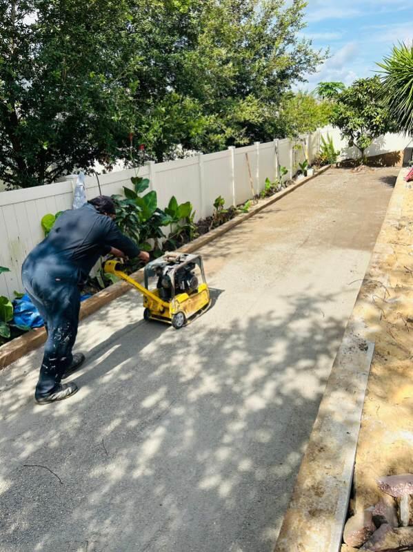 Worker compacting the cobble field
