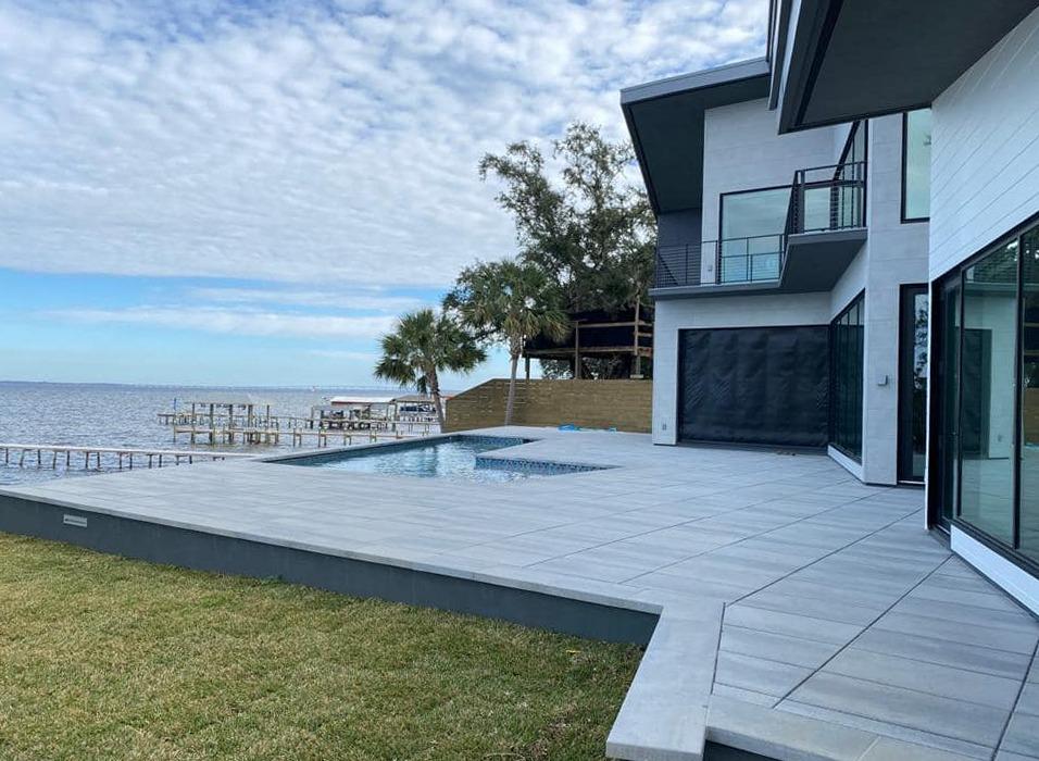 Modern paver pool deck overlooking a Central Florida lake