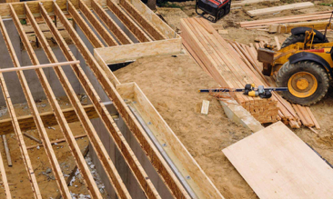 Wood framing aerial view with equipment on site