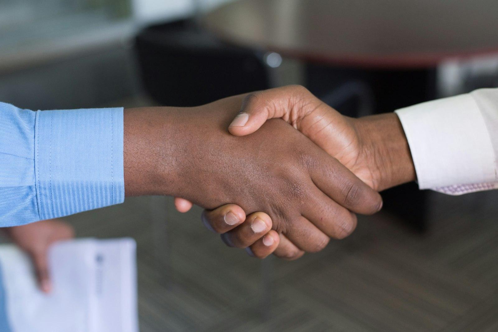 Close-up handshake between a homeowner and a contractor